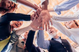 group gathers in a circle and gives energy with joined hands after a team building