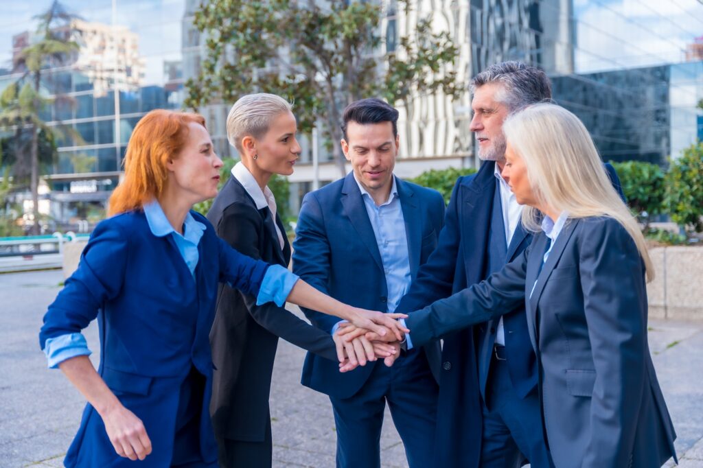 Senior Executives Unite with High-Five Gesture in Team Building and Collaboration
